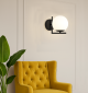 Kinkiet czarny z białą kulą Milano Sun i żółty fotel.png
